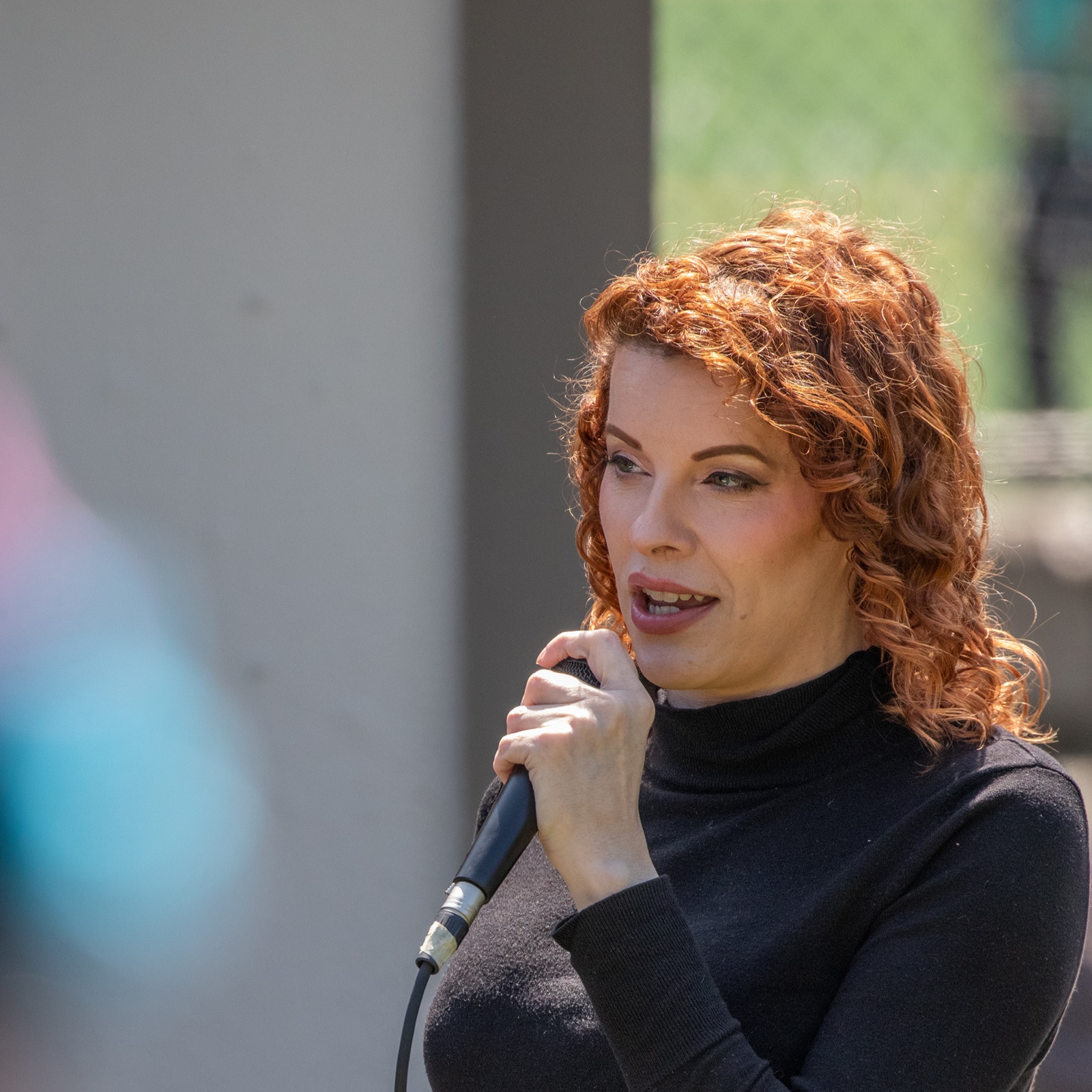 Danni speaking at a rally on trans refugees in Seattle, 2025